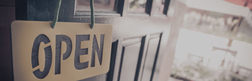 An open door to a business open with an open sign on it